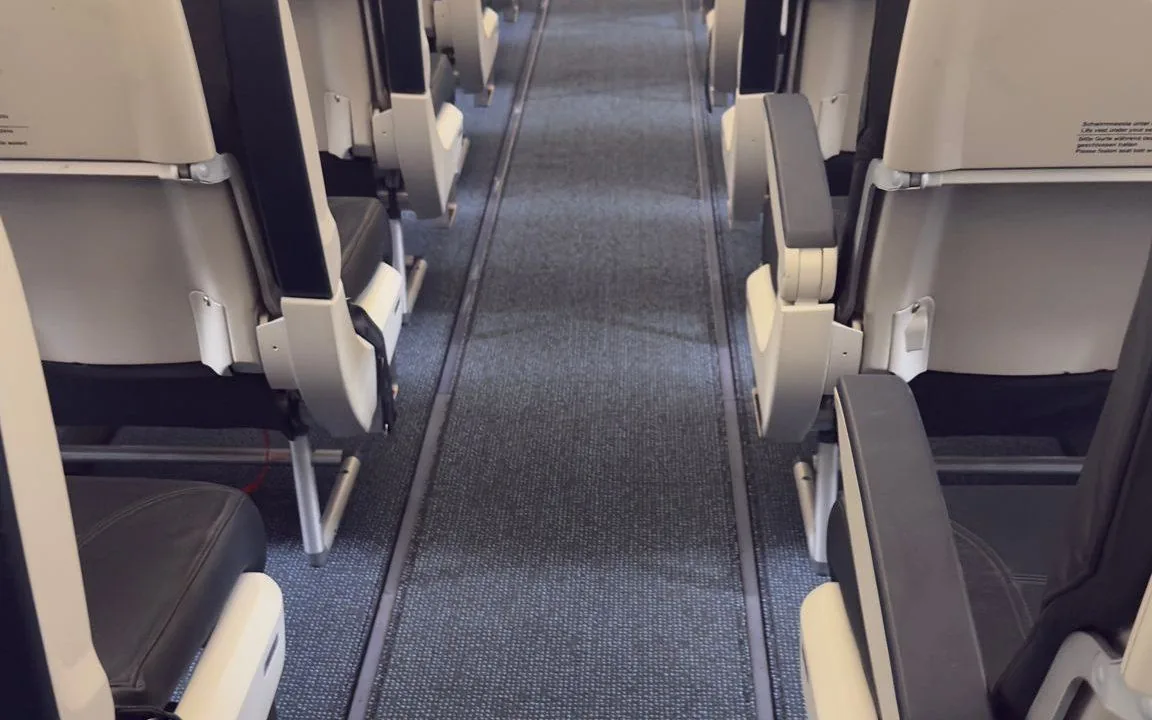 Aircraft cabin aisle with newly installed carpet