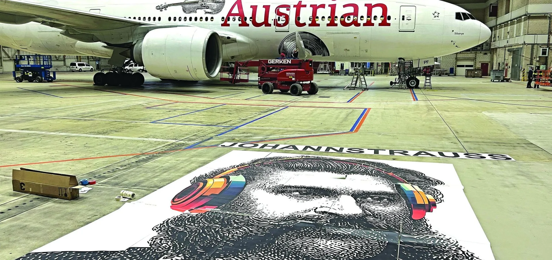 Austrian Airlines Boeing 777 in Hangar 2 with the printed Johann Strauss vinyl laid out on the hangar floor