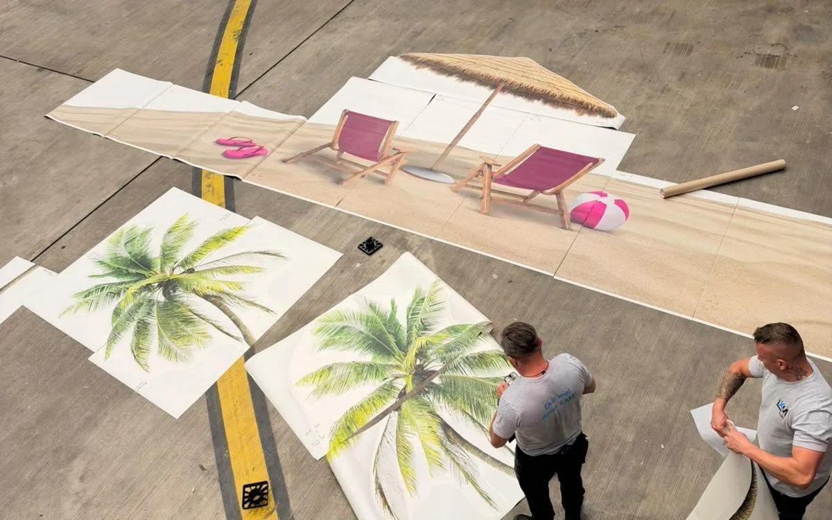 Printed livery vinyl sections laid out on the apron before application